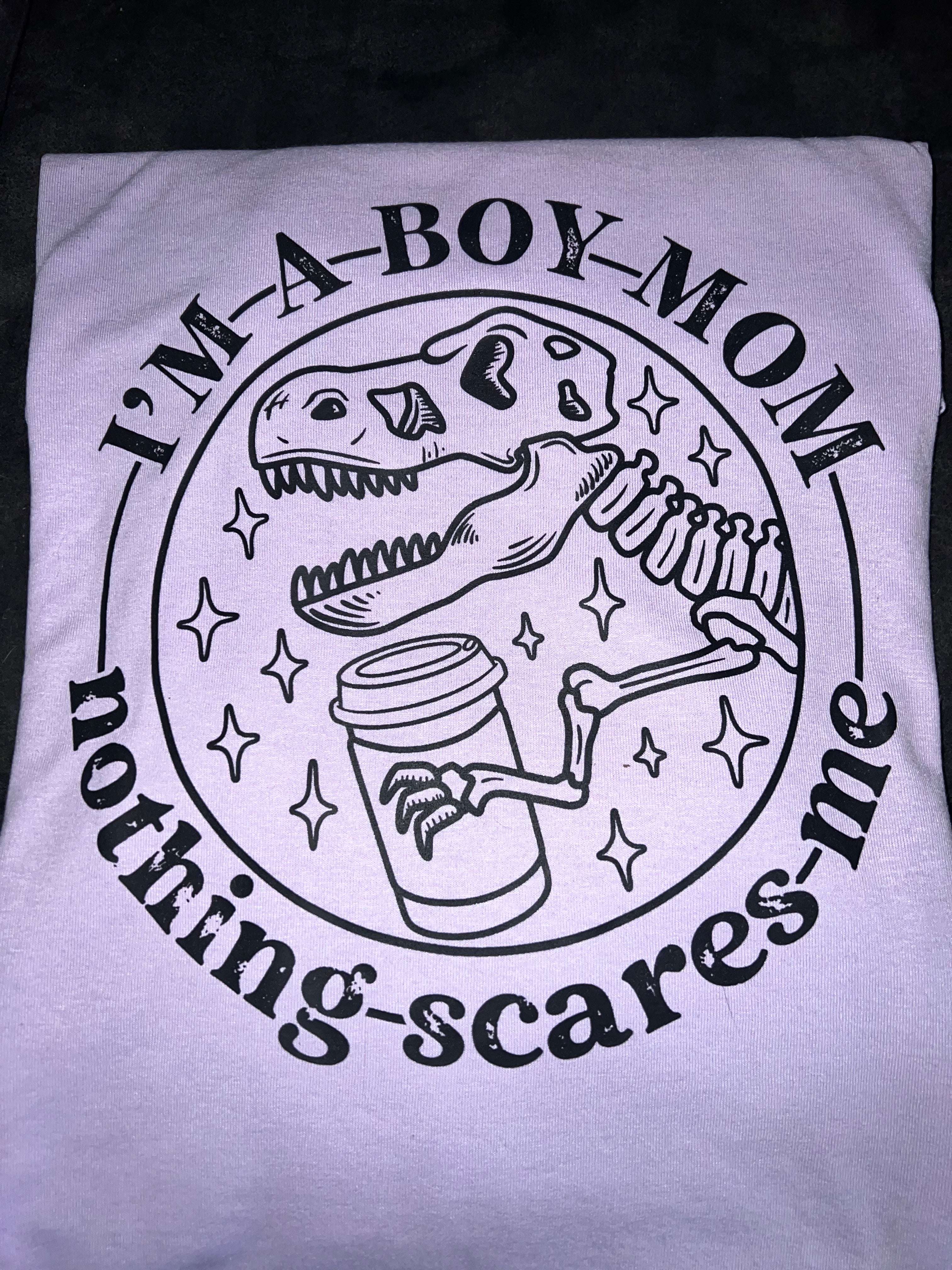 Dinosaur Mom Life Tee: 'I'm a Boy Mom, Nothing Scares Me' with Playful Dino Design Dress Your Story: Explore our Diverse T-shirt Collection - Humor, Inspiration, Professions, Retro, Boho, and Country Advocacy in Vibrant Colors, Sizes, and Styles T-Shirt 22 Daisy Designs & Creations LLC