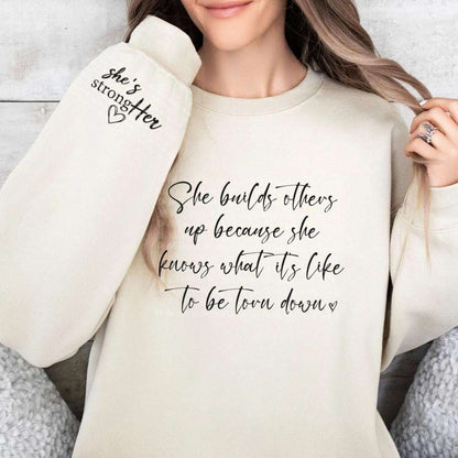 "Empowering Crewneck - She Builds Others Up with StrongHER Arm Patch" Cozy Elegance: Explore Our Crewneck and Hoodie Collection for Effortless Style Crewneck 24 Daisy Designs & Creations LLC