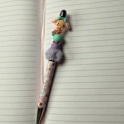 Pen with decorative cap on an open notebook