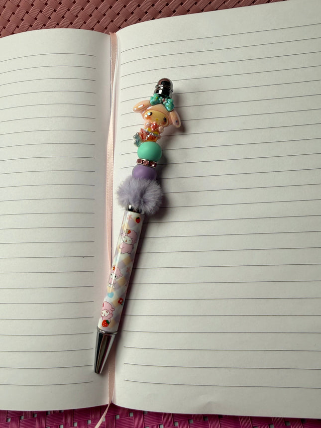 Pen with decorative cap on an open notebook