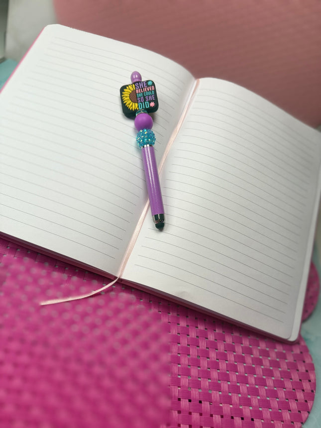 Purple Shimmer Stylus Pen With focal that says, She believed she could So She did with half sunflower. Features Purple silicone bead & rhinestone turquoise bead. 