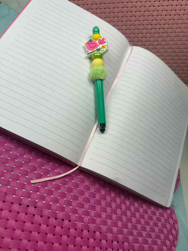 Beaded Stylus with little pink focal featuring a little pink song bird. Stylus is shimmering green with yellow silicone beads and fluffy green spacer 