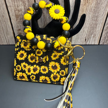 Handmade sunflower faux leather wallet with matching silicone beaded wristlet, sunflower focal bead, removable tassel, clear ID holder, gold hardware, and sunflower print.