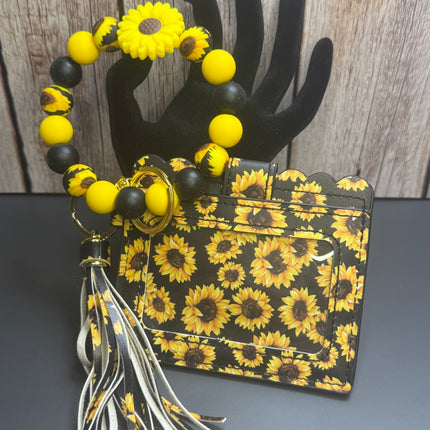 Handmade sunflower faux leather wallet with matching silicone beaded wristlet, sunflower focal bead, removable tassel, clear ID holder, gold hardware, and sunflower print.