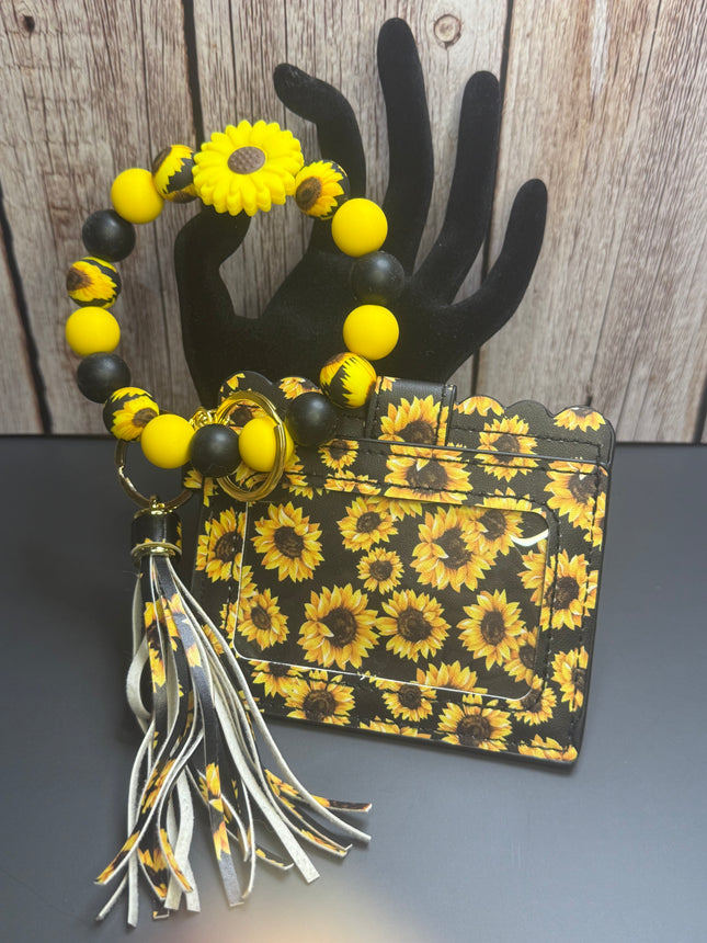 Handmade sunflower faux leather wallet with matching silicone beaded wristlet, sunflower focal bead, removable tassel, clear ID holder, gold hardware, and sunflower print.