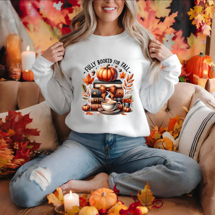 White Fully Booked for Fall sweatshirt featuring stacked books, pumpkin, steaming coffee and autumn leaves.