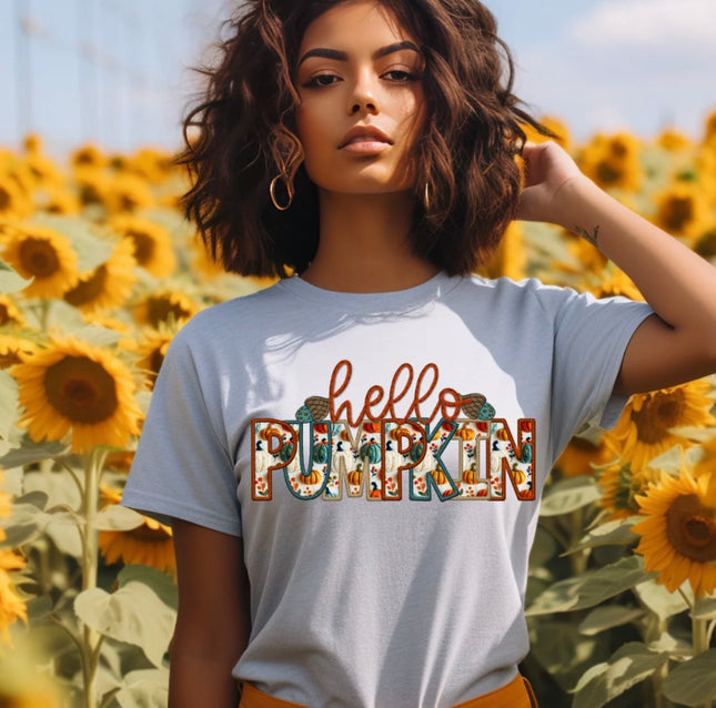 Gray T-shirt with Hello Pumpkin graphic featuring autumn-colored patterned lettering and small pumpkin details.
