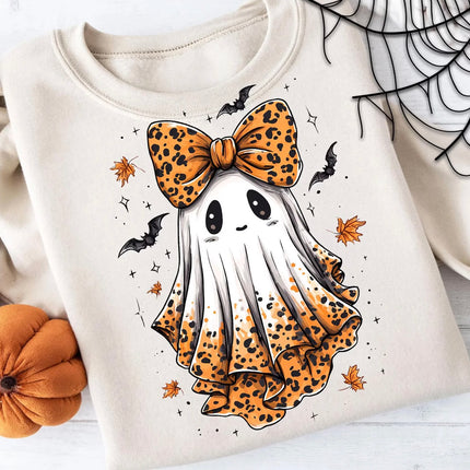 A folded cream-colored sweatshirt featuring a cute cartoon ghost graphic with an orange and black leopard print bow, ruffled leopard print hem, and small black bats and orange leaves on a white background.