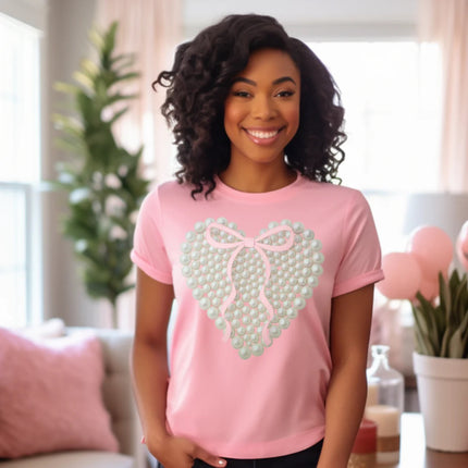 Woman wearing a pink t-shirt with a heart design in a home setting